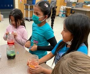 students listening to the next direction in order to create their own lava lamps